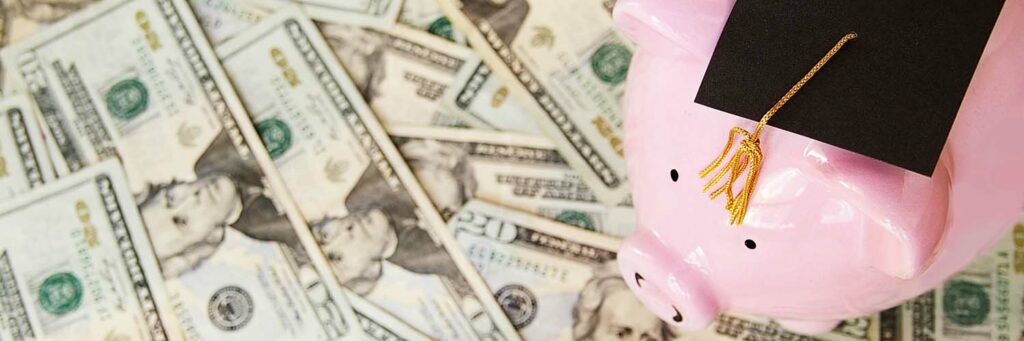 Piggy with graduation cap on money