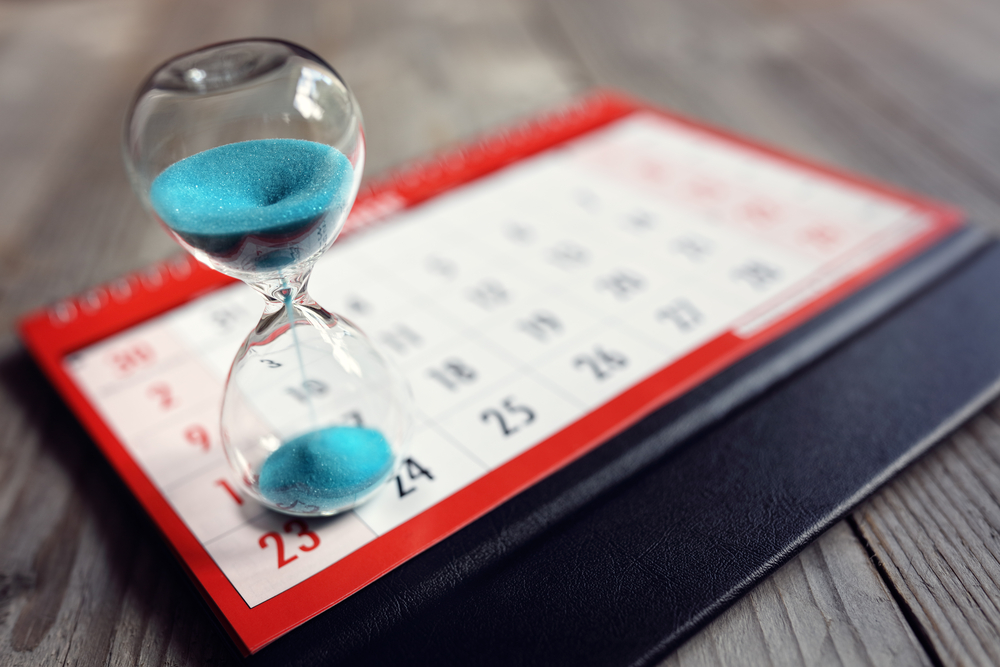 photo of an hourglass on a paper calendar