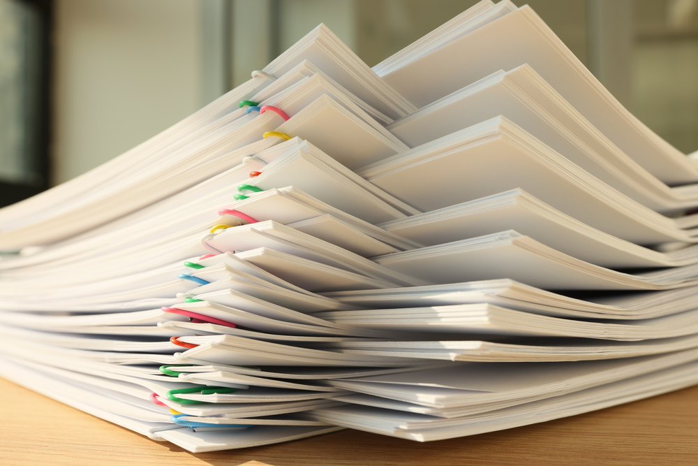 Stack of alternating groups of papers with colored paper clips