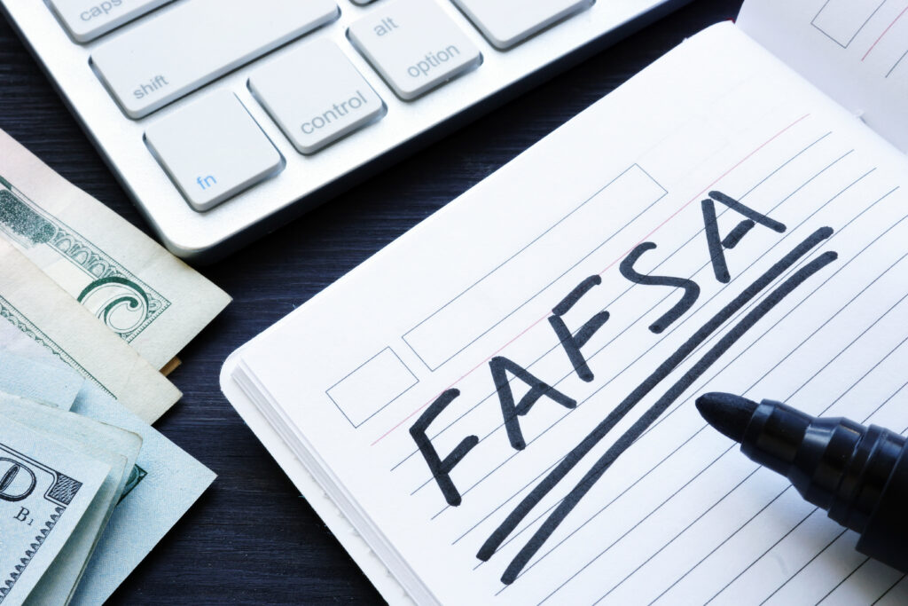 FAFSA handwritten in a note. Free Application for Federal Student Aid.